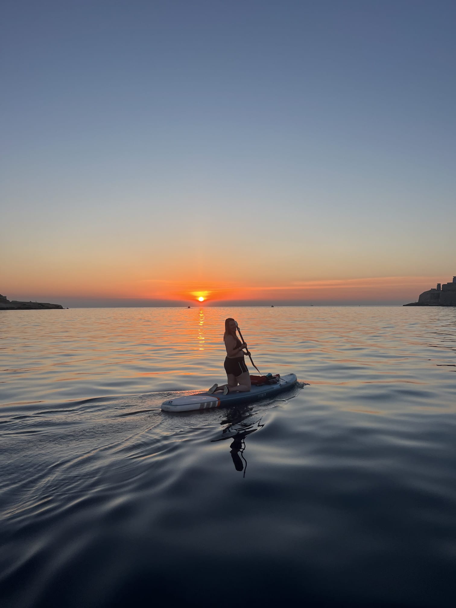 Paddleboarding at sunset in Marsalforn Bay
