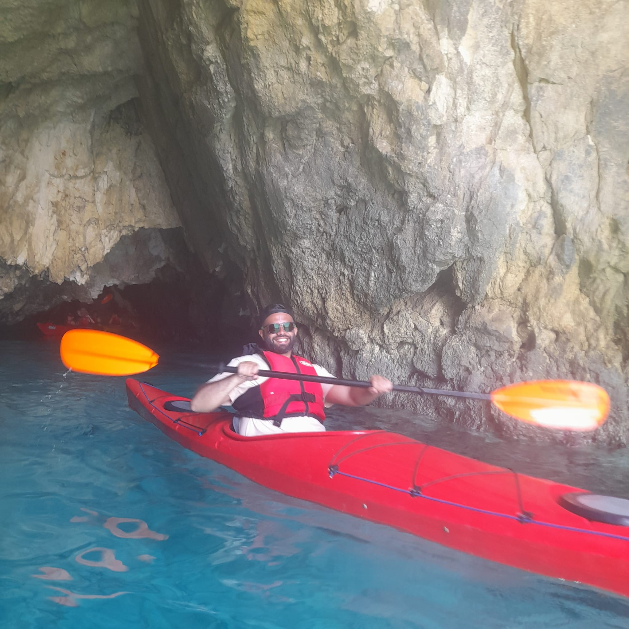 Kayaking through a sea cave at Wied il-Għasri
